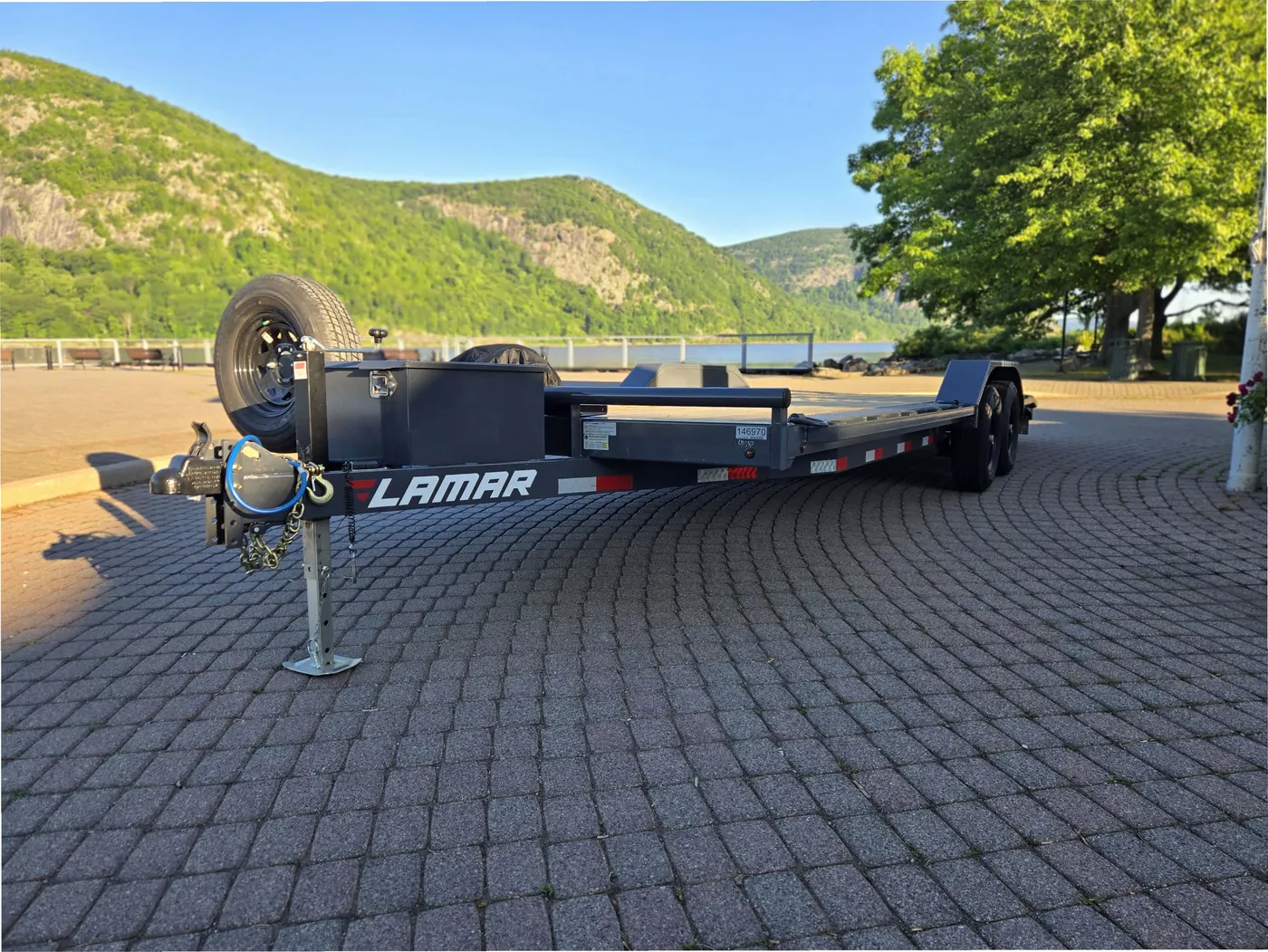 Lamar 102-inch by 22-foot medium-duty car hauler rental with Storm King Mountain behind, Hudson Valley NY