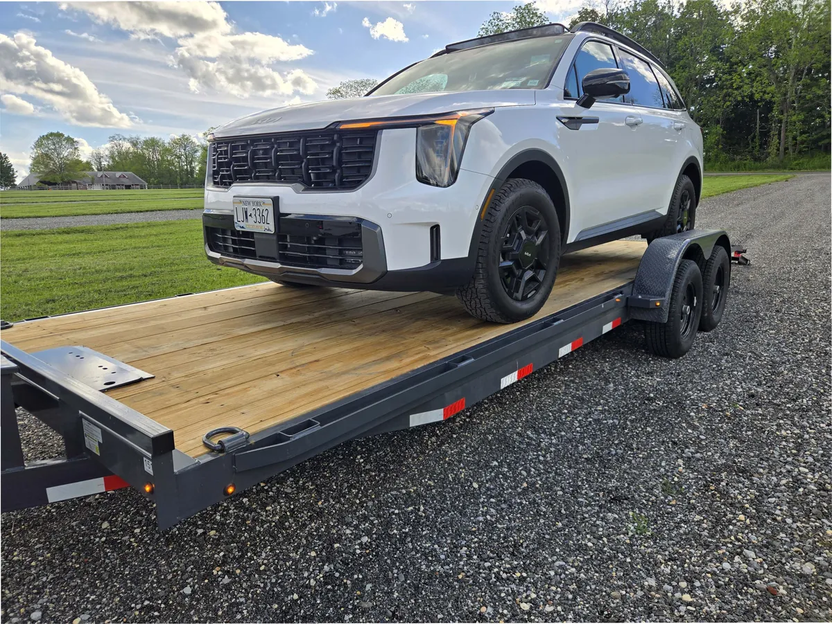 An SUV strapped down and hauled on the Mainline 102-inch car hauler