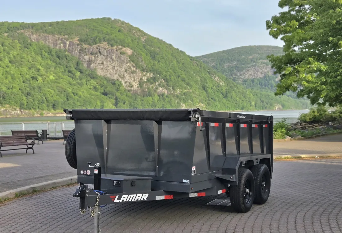 Hydraulic dump trailer rental with Storm King Mountain and the Hudson River behind